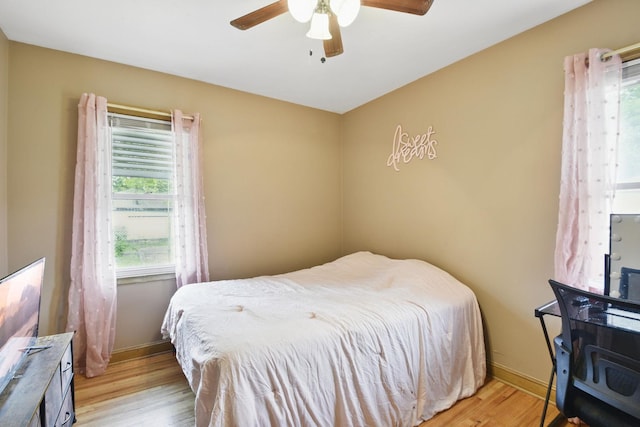6001 Bryant Ave N, Brooklyn Center, MN 55430 - bedroom with light wood-style floors, baseboards, and a ceiling fan