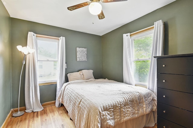 6001 Bryant Ave N, Brooklyn Center, MN 55430 - bedroom featuring baseboards, wood finished floors, and ceiling fan