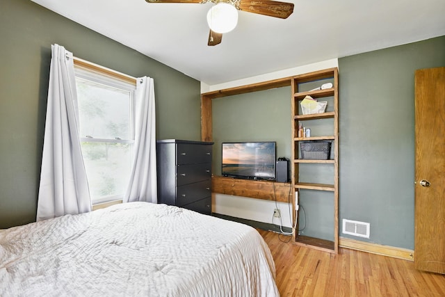 6001 Bryant Ave N, Brooklyn Center, MN 55430 - bedroom with wood finished floors, baseboards, and a ceiling fan