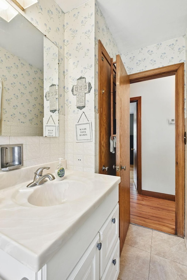 6001 Bryant Ave N, Brooklyn Center, MN 55430 - bathroom featuring wallpapered walls, vanity, and tile patterned flooring