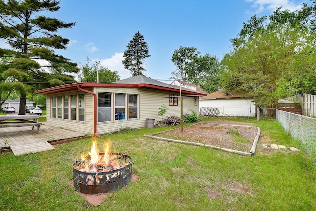 6001 Bryant Ave N, Brooklyn Center, MN 55430 - rear view of house with an outdoor fire pit and a deck
