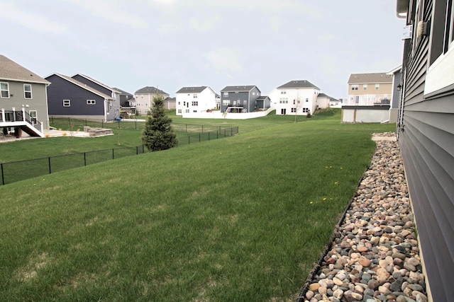 view of yard with fence and a residential view