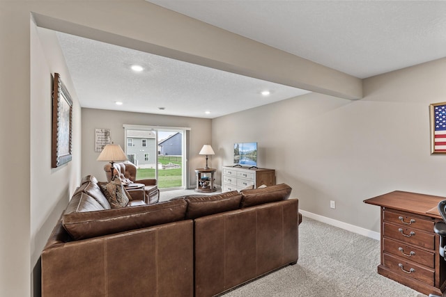 living area with recessed lighting, baseboards, light colored carpet, and a textured ceiling