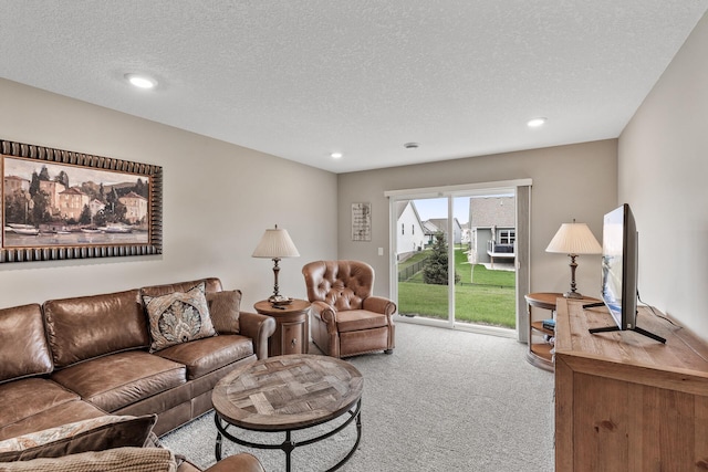 carpeted living room with recessed lighting and a textured ceiling