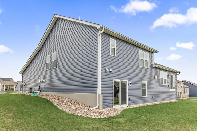 back of property with a lawn and cooling unit