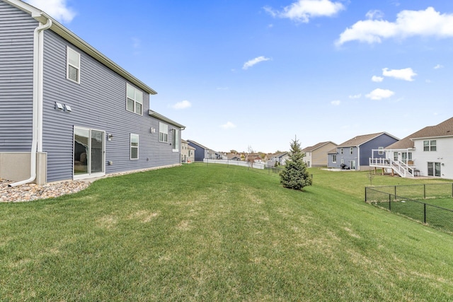 view of yard with fence and a residential view