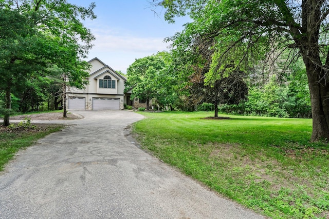 7884 341st St, Lent Twp, MN 55079 - view of front facade featuring asphalt driveway, a garage, and a front yard