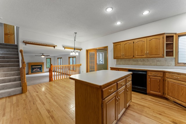 7884 341st St, Lent Twp, MN 55079 - kitchen with dishwasher, a textured ceiling, a center island, light wood-style flooring, and open floor plan
