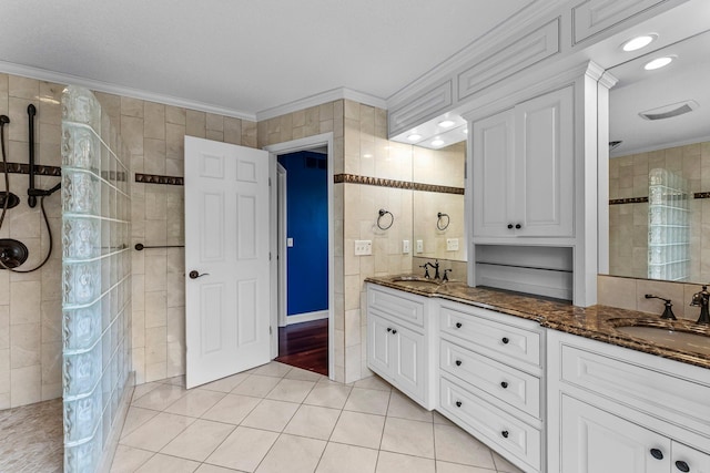 7884 341st St, Lent Twp, MN 55079 - bathroom featuring ornamental molding, double vanity, a walk in shower, tile patterned flooring, and tile walls