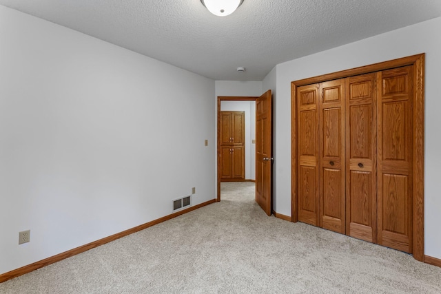 7884 341st St, Lent Twp, MN 55079 - unfurnished bedroom with carpet flooring, a textured ceiling, and a closet