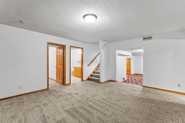 7884 341st St, Lent Twp, MN 55079 - carpeted spare room featuring stairway and a textured ceiling