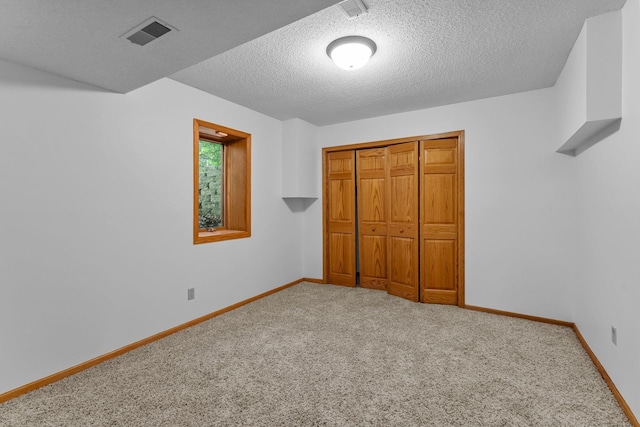 7884 341st St, Lent Twp, MN 55079 - unfurnished bedroom featuring carpet flooring, a textured ceiling, and a closet