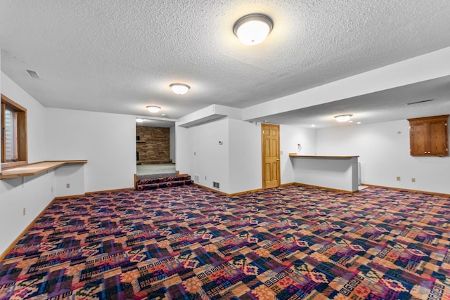 7884 341st St, Lent Twp, MN 55079 - finished below grade area with carpet, a bar, and a textured ceiling