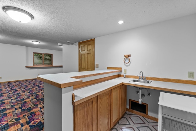 7884 341st St, Lent Twp, MN 55079 - kitchen with light countertops, a textured ceiling, recessed lighting, a peninsula, and brown cabinets