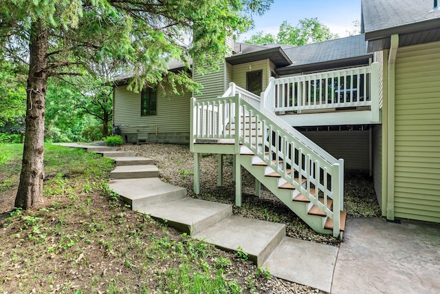 7884 341st St, Lent Twp, MN 55079 - doorway to property with a wooden deck and roof with shingles