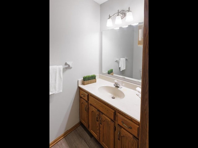 bathroom with vanity and wood finished floors