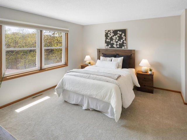 bedroom with carpet and baseboards