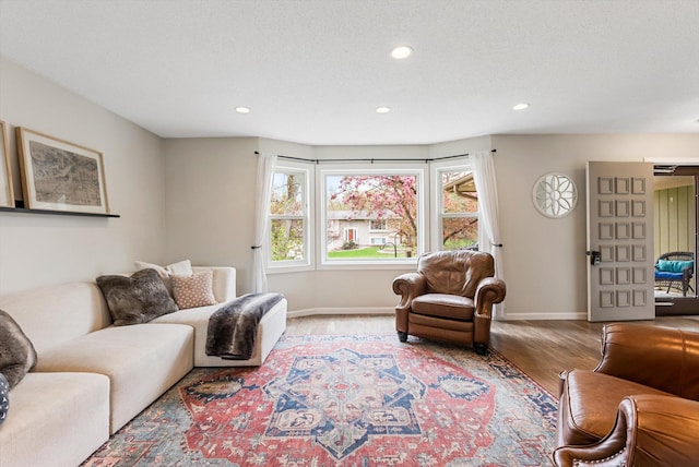 living room with a healthy amount of sunlight, recessed lighting, and wood finished floors