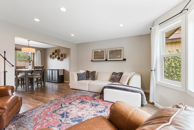 living area with baseboards, recessed lighting, and wood finished floors