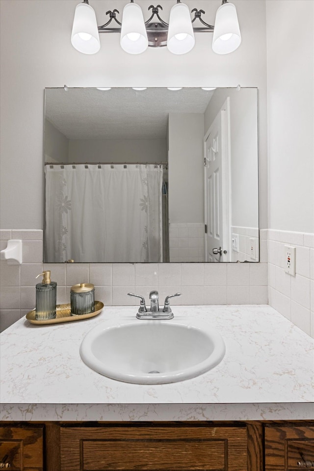 full bath featuring vanity and backsplash