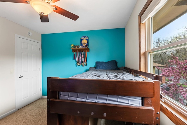 carpeted bedroom with ceiling fan