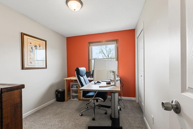 carpeted office featuring baseboards