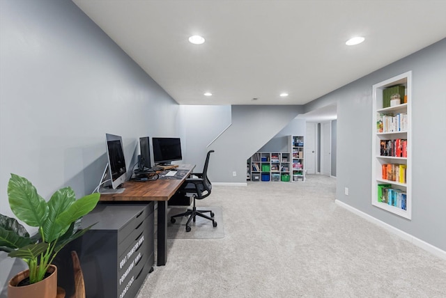 office space with recessed lighting, baseboards, light carpet, and built in features