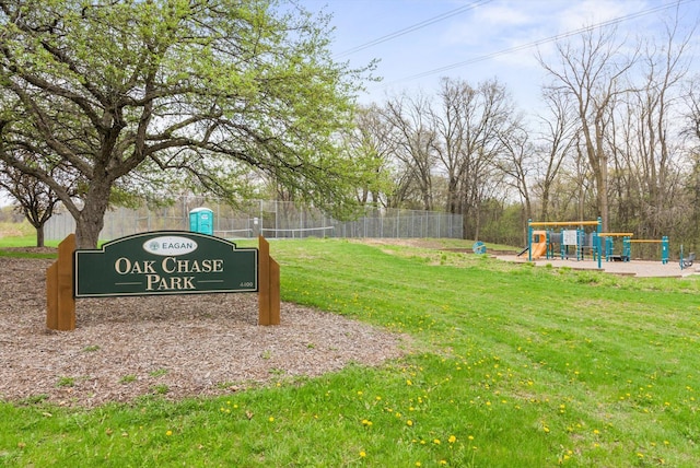 community sign with a lawn and fence