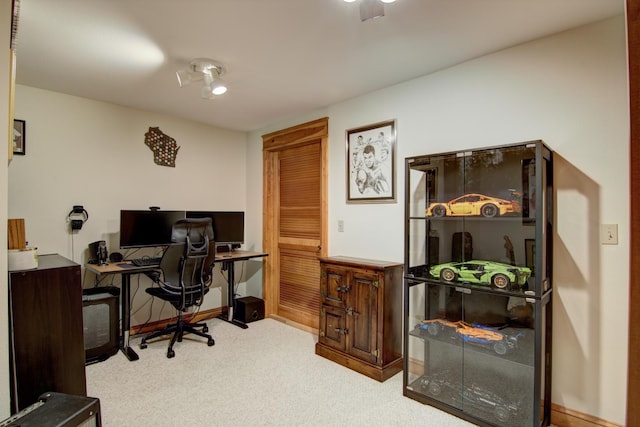 office area featuring baseboards and carpet flooring