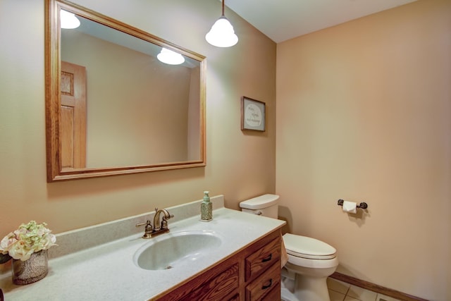 bathroom with tile patterned floors, vanity, and toilet