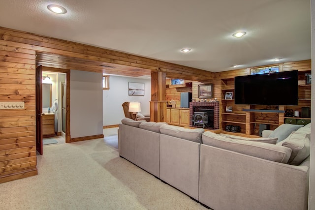 living room with recessed lighting, baseboards, wood walls, and light carpet