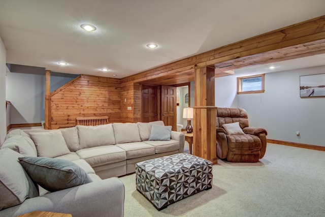 carpeted living area with baseboards, wood walls, and recessed lighting