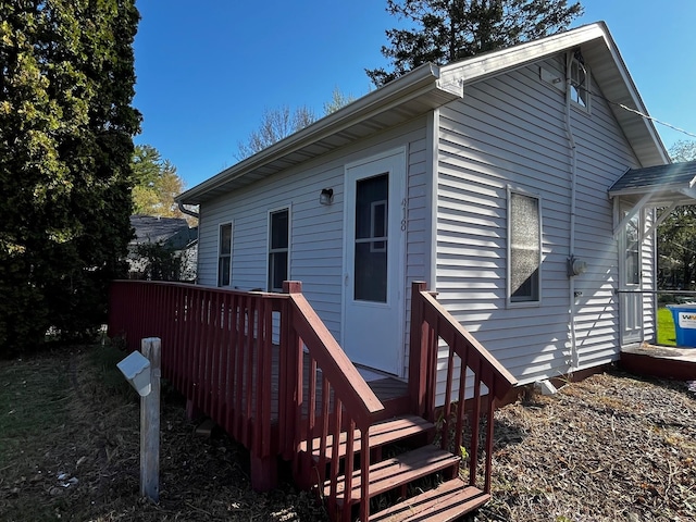 rear view of house featuring a wooden deck