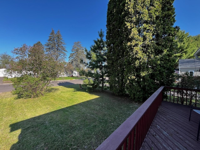 view of grassy yard featuring a wooden deck