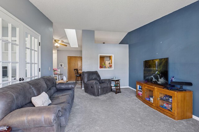 carpeted living room featuring baseboards, a ceiling fan, and a textured ceiling