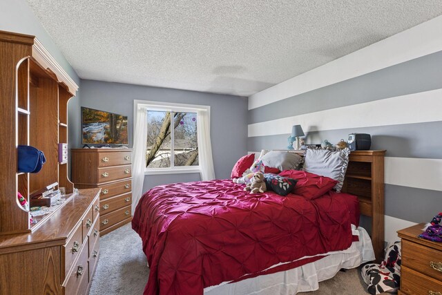carpeted bedroom featuring a textured ceiling