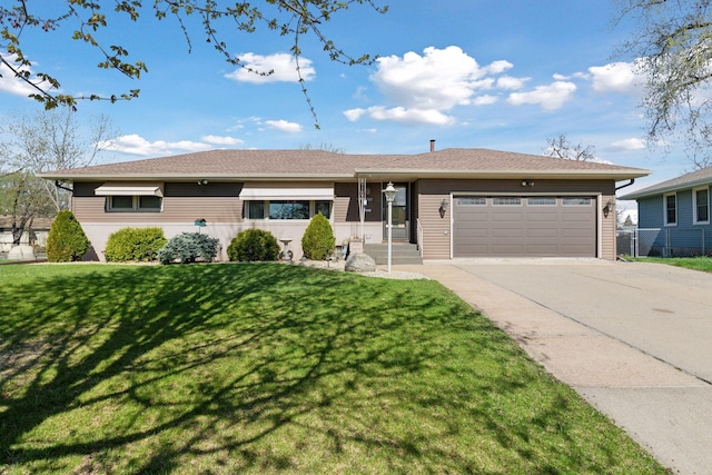 6309 Halifax Dr, Brooklyn Center, MN 55429 - view of front of home featuring an attached garage, concrete driveway, and a front lawn