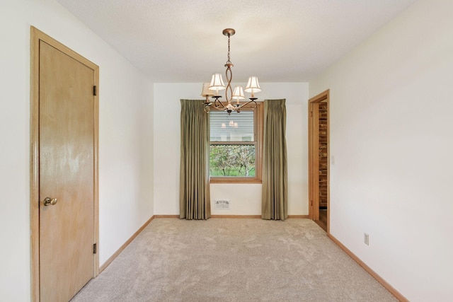 6309 Halifax Dr, Brooklyn Center, MN 55429 - unfurnished room with light colored carpet, baseboards, a chandelier, and visible vents