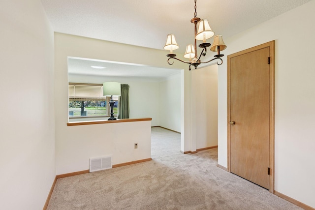 6309 Halifax Dr, Brooklyn Center, MN 55429 - unfurnished room featuring visible vents, carpet flooring, baseboards, and an inviting chandelier
