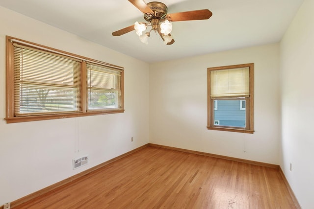 6309 Halifax Dr, Brooklyn Center, MN 55429 - empty room with a ceiling fan, baseboards, visible vents, and light wood finished floors