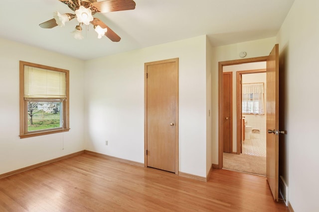6309 Halifax Dr, Brooklyn Center, MN 55429 - unfurnished bedroom featuring baseboards, ceiling fan, and light wood finished floors