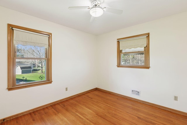 6309 Halifax Dr, Brooklyn Center, MN 55429 - spare room with baseboards, visible vents, ceiling fan, and light wood-style floors