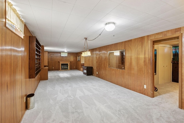 6309 Halifax Dr, Brooklyn Center, MN 55429 - finished basement with wooden walls, carpet flooring, and a glass covered fireplace