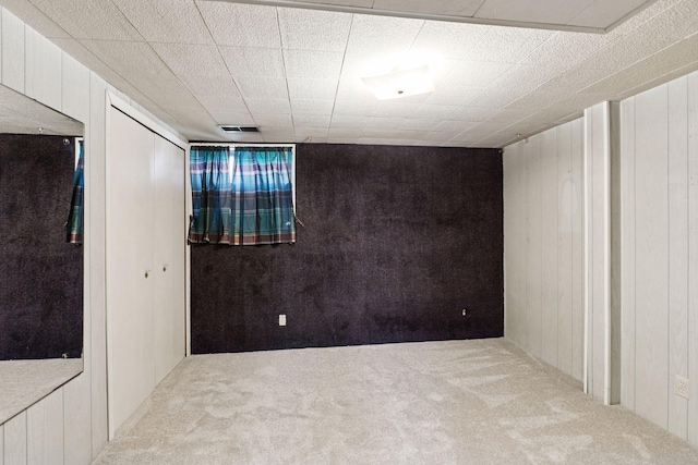 6309 Halifax Dr, Brooklyn Center, MN 55429 - finished below grade area with wooden walls, visible vents, and carpet