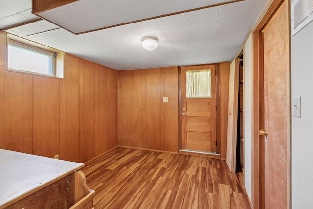 6309 Halifax Dr, Brooklyn Center, MN 55429 - interior space with wooden walls, light wood finished floors, and visible vents