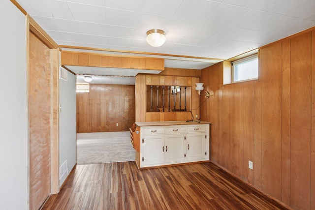 6309 Halifax Dr, Brooklyn Center, MN 55429 - bar featuring visible vents, baseboards, wood finished floors, and wooden walls