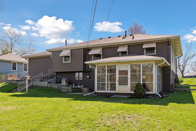 6309 Halifax Dr, Brooklyn Center, MN 55429 - back of house with a lawn, central AC unit, and a sunroom