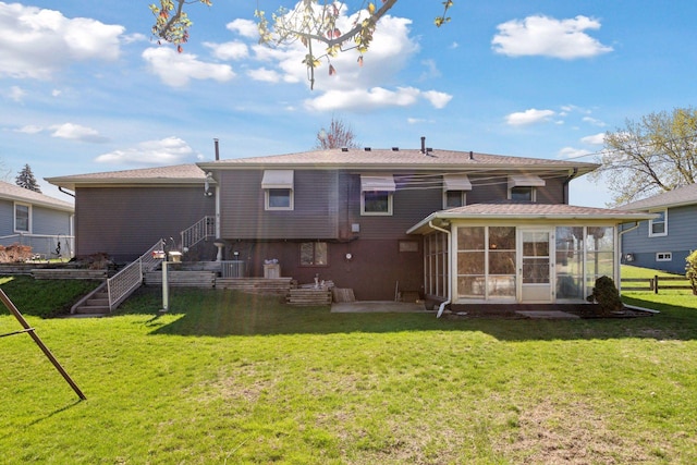 6309 Halifax Dr, Brooklyn Center, MN 55429 - rear view of house with a lawn and a sunroom