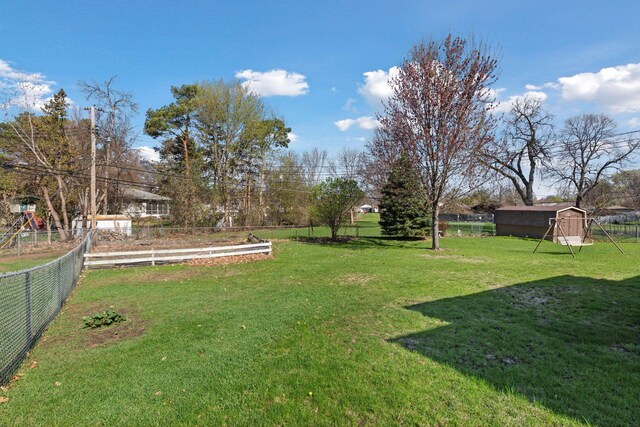 6309 Halifax Dr, Brooklyn Center, MN 55429 - view of yard featuring fence and an outbuilding