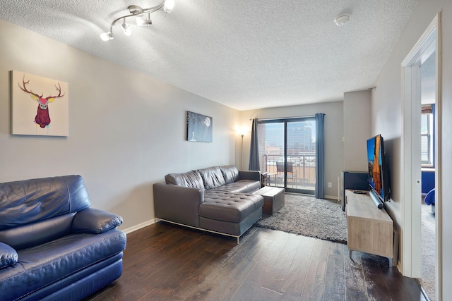 living area featuring baseboards, a textured ceiling, and wood finished floors